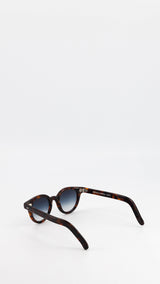 Les lunettes Vincent en acétate marron jaspé verres solaires dégradés, coloris bleu gris, de la collection André Malraux par Maison Gabriel Paris