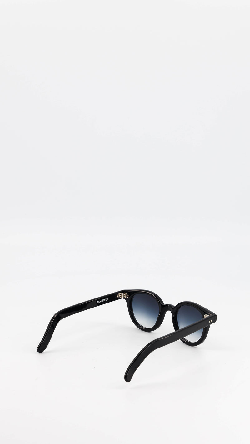 Les lunettes Vincent en acétate noire verres solaires dégradés, coloris bleu gris, de la collection André Malraux par Maison Gabriel Paris