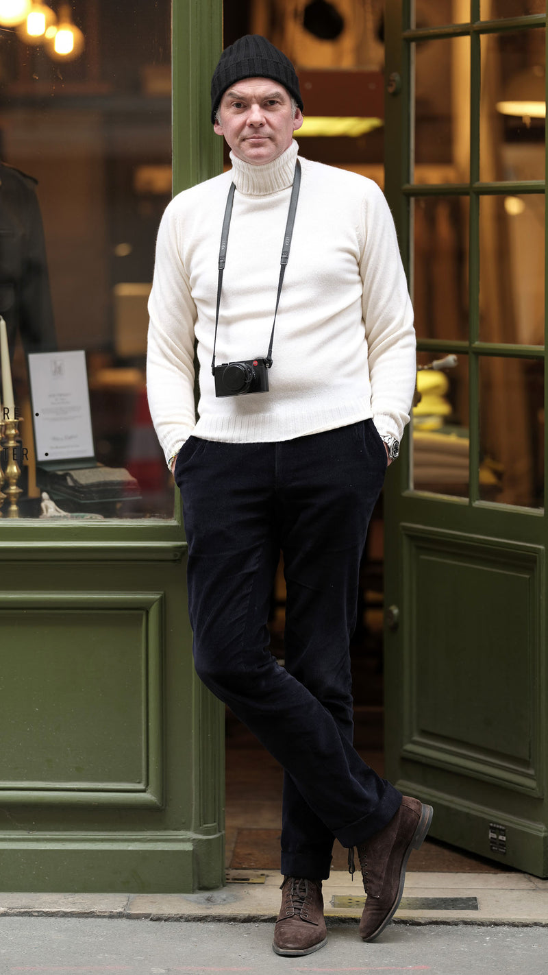 Cyril devant la boutique porte le pull Basile en laine et cachemire blanc col roulé de la Maison Gabriel Paris