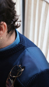 Titouan au Sand à Paris porte le cardigan Ayden en laine bleu marine LE MINOR X GABRIEL - détail de la double boutonnière pour glisser ses lunettes - Collection Automne Hiver 2025 - Maison Gabriel Paris