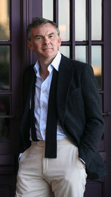 Cyril à Trouville porte de manière décontractée la veste droite Albert en bouclette de laine noire de la collection Automne Hiver 2024 Maison Gabriel Paris